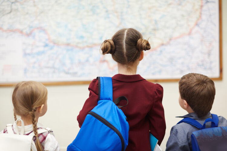 School children looking at a map